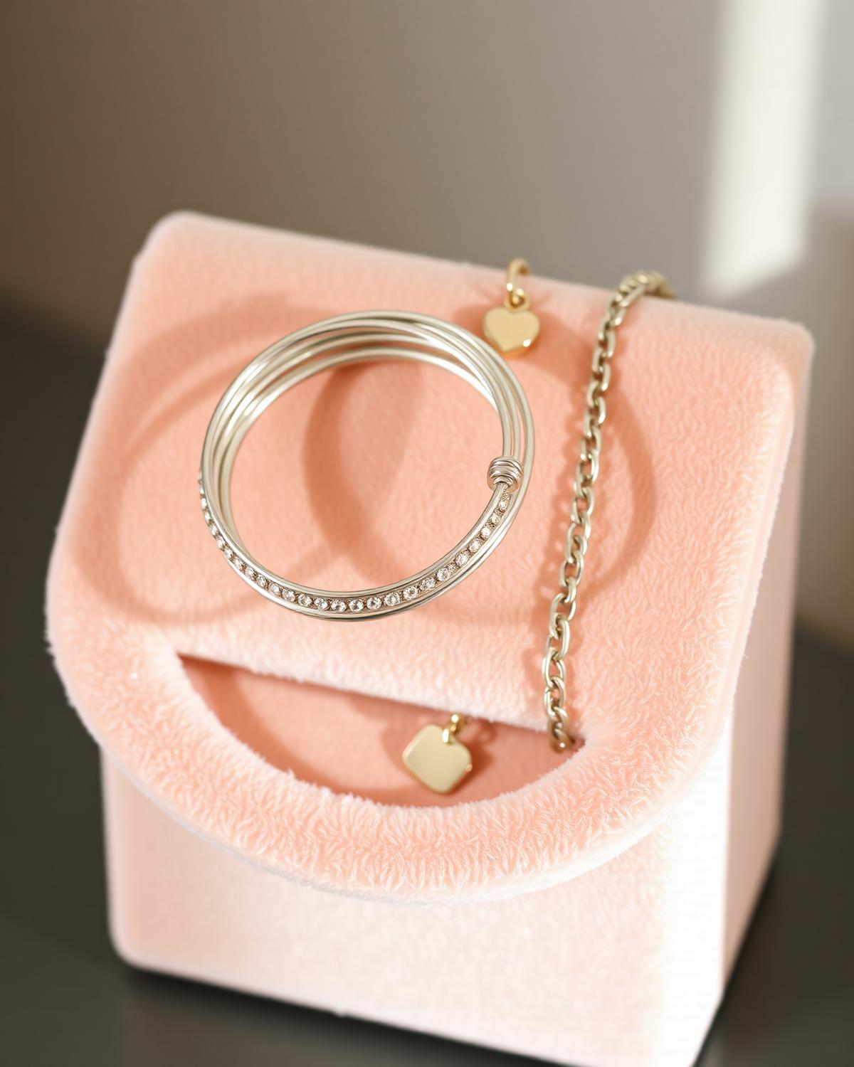 Bangles and a charm bracelet stacked together